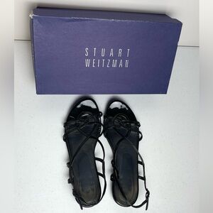 Stuart Weitzman black patent leather, a multi-strap gladiator-style sandals